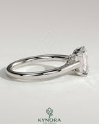 Kynora CJ 2ct emerald claw solitaire engagement ring with spiral gallery and cathedral low setting, showcasing a sparkling emerald gemstone.