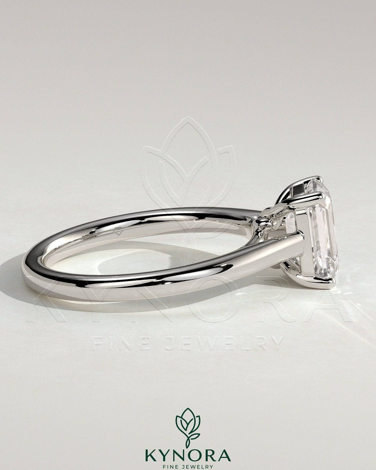 Kynora CJ 2ct emerald claw solitaire engagement ring with spiral gallery and cathedral low setting, showcasing a sparkling emerald gemstone.
