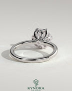 Kynora CJ 2ct round claw solitaire engagement ring with crossover petal gallery design, showcasing a sparkling central diamond.