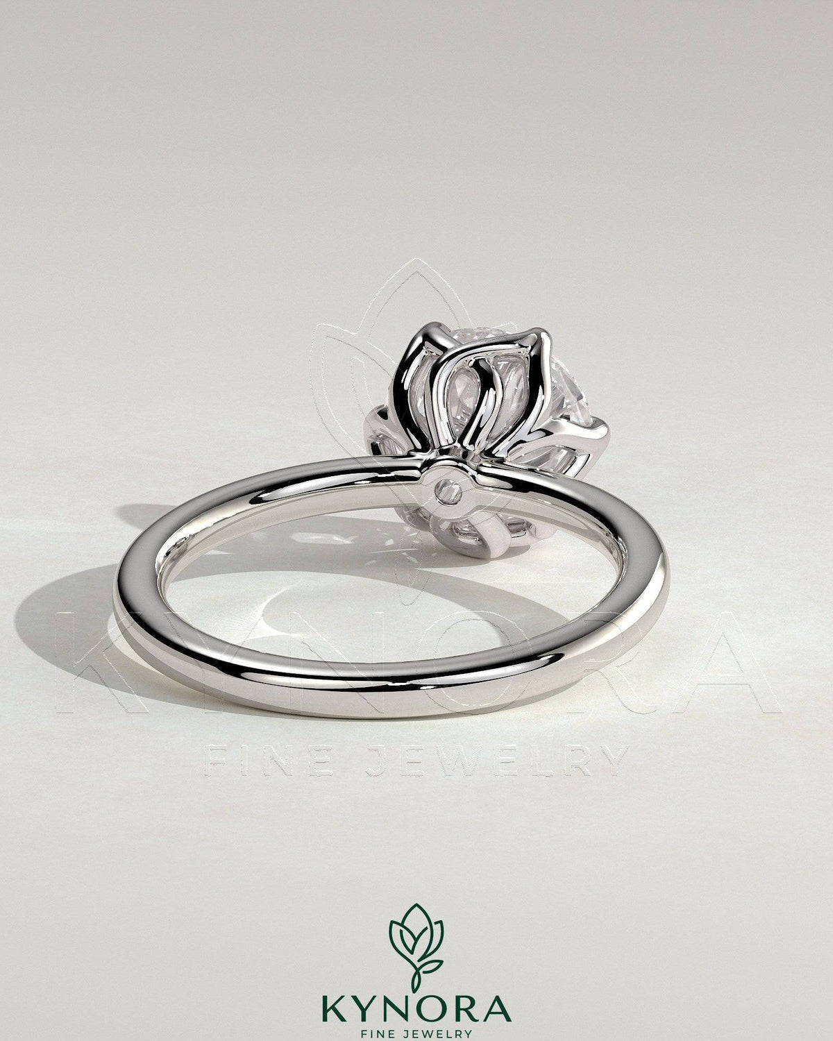Kynora CJ 2ct round claw solitaire engagement ring with crossover petal gallery design, showcasing a sparkling central diamond.