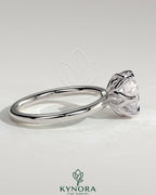 Kynora CJ 2ct round claw solitaire engagement ring with crossover petal gallery design, featuring a sparkling central diamond.
