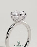 Kynora CJ 2ct round diamond claw solitaire engagement ring with crossover petal gallery design on a white background.