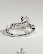 Kynora CJ 2ct oval claw solitaire engagement ring with round-marquise bezel accent stones, elegant and sparkling jewelry piece.