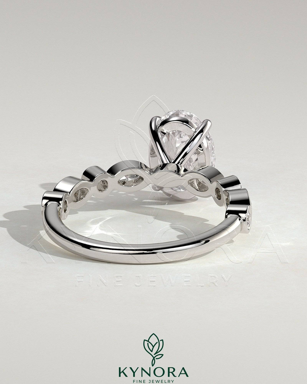 Kynora CJ 2ct oval claw solitaire engagement ring with round-marquise bezel accent stones, elegant and sparkling jewelry piece.