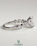 Kynora CJ 2ct oval claw solitaire engagement ring with round marquise bezel accent stones, crafted in fine jewelry style.