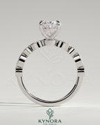 Kynora CJ 2ct oval claw solitaire engagement ring with round-marquise bezel accent stones, elegant and sparkling jewelry piece.