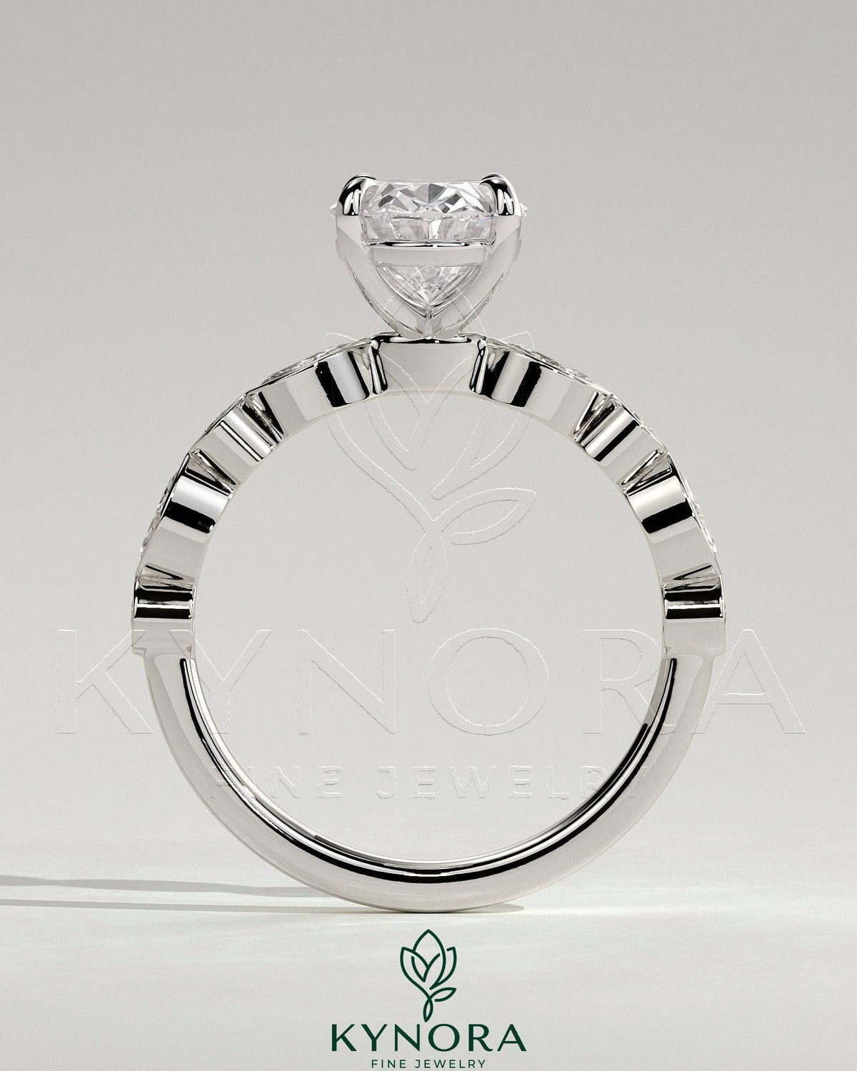 Kynora CJ 2ct oval claw solitaire engagement ring with round-marquise bezel accent stones, elegant and sparkling jewelry piece.