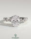 Kynora CJ 2ct oval claw solitaire engagement ring with round-marquise bezel accent stones, showcasing a sparkling elegant design