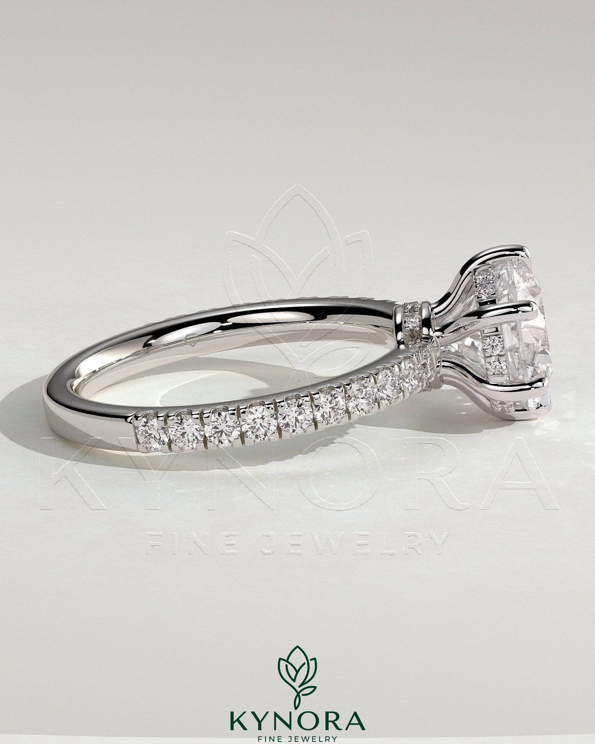 Kynora CJ 2ct round claw solitaire engagement ring with hidden halo, pave collar, and pave band showcasing sparkling diamond details.
