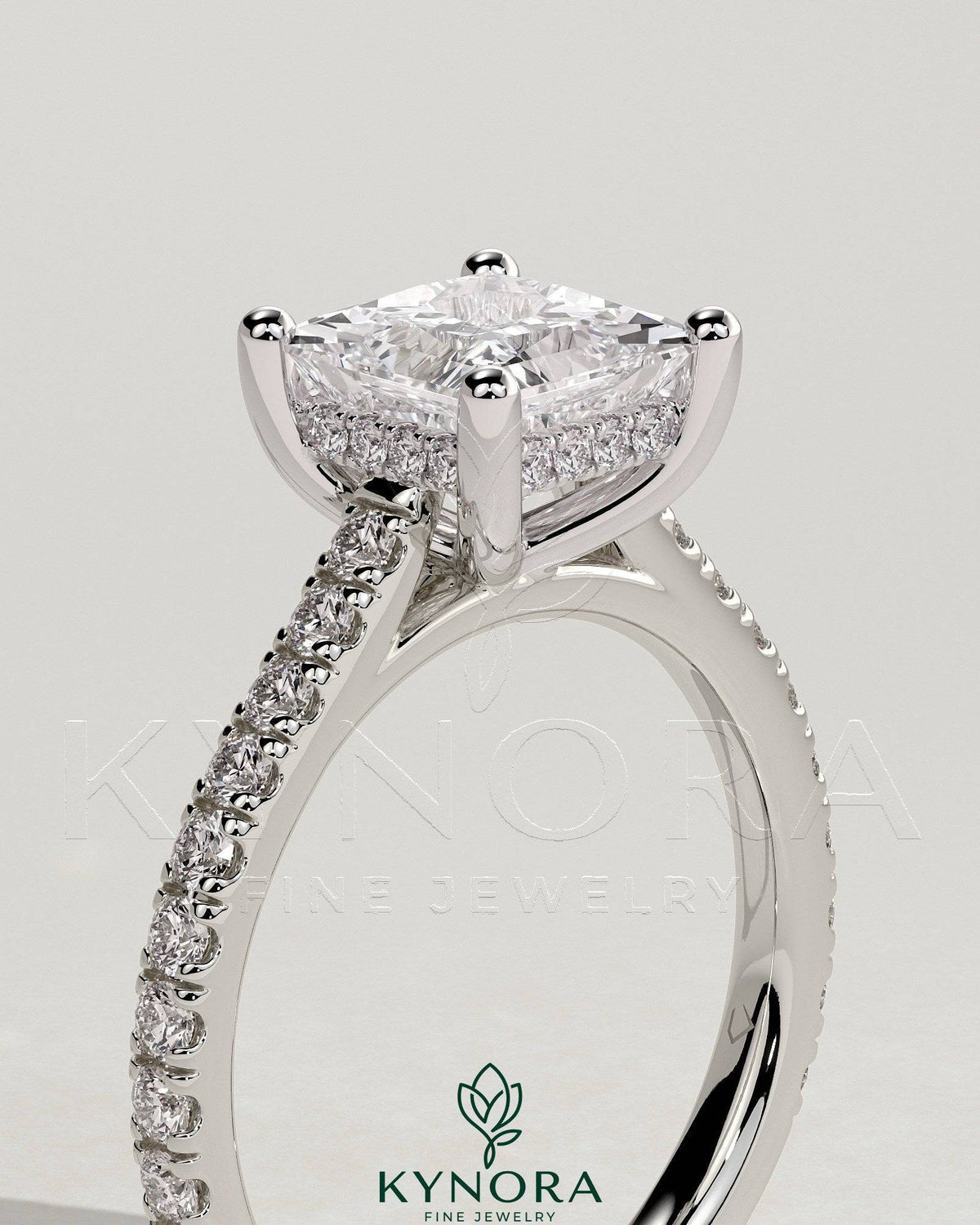 Kynora CJ 2ct princess claw solitaire engagement ring with hidden halo, pave band, and cathedral high setting.