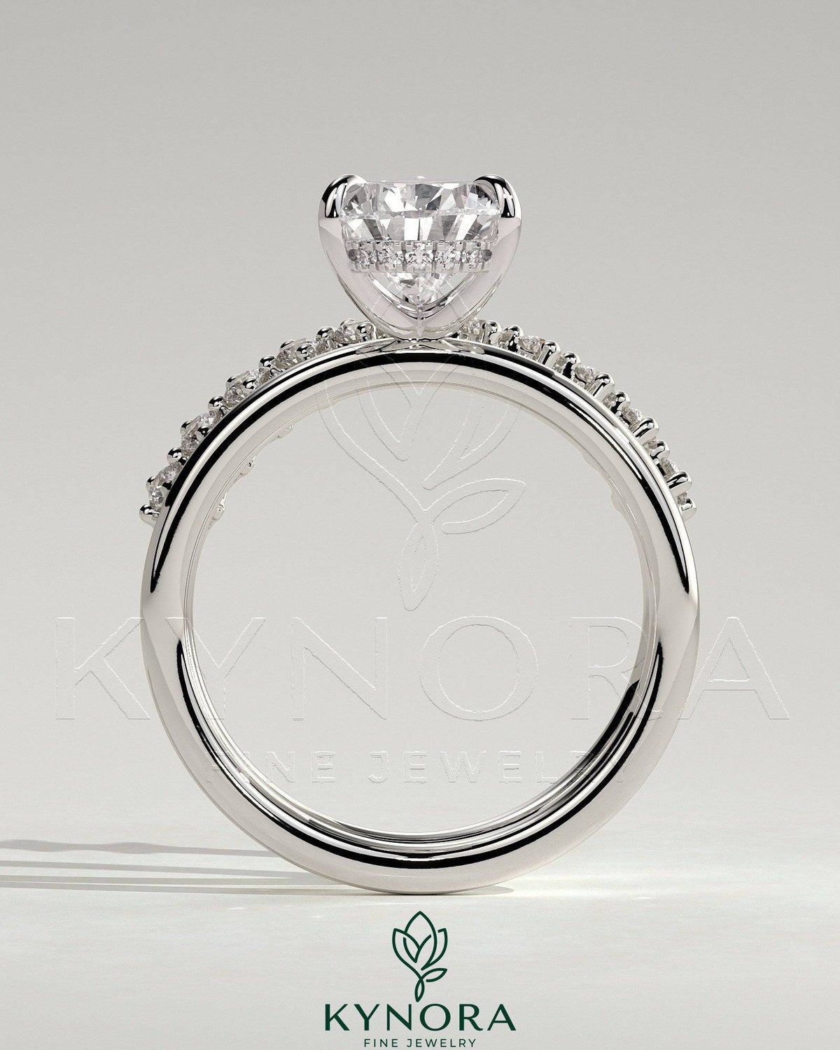 Kynora CJ 2ct pear-shaped diamond solitaire engagement ring with double plain and round accent stones on the band.
