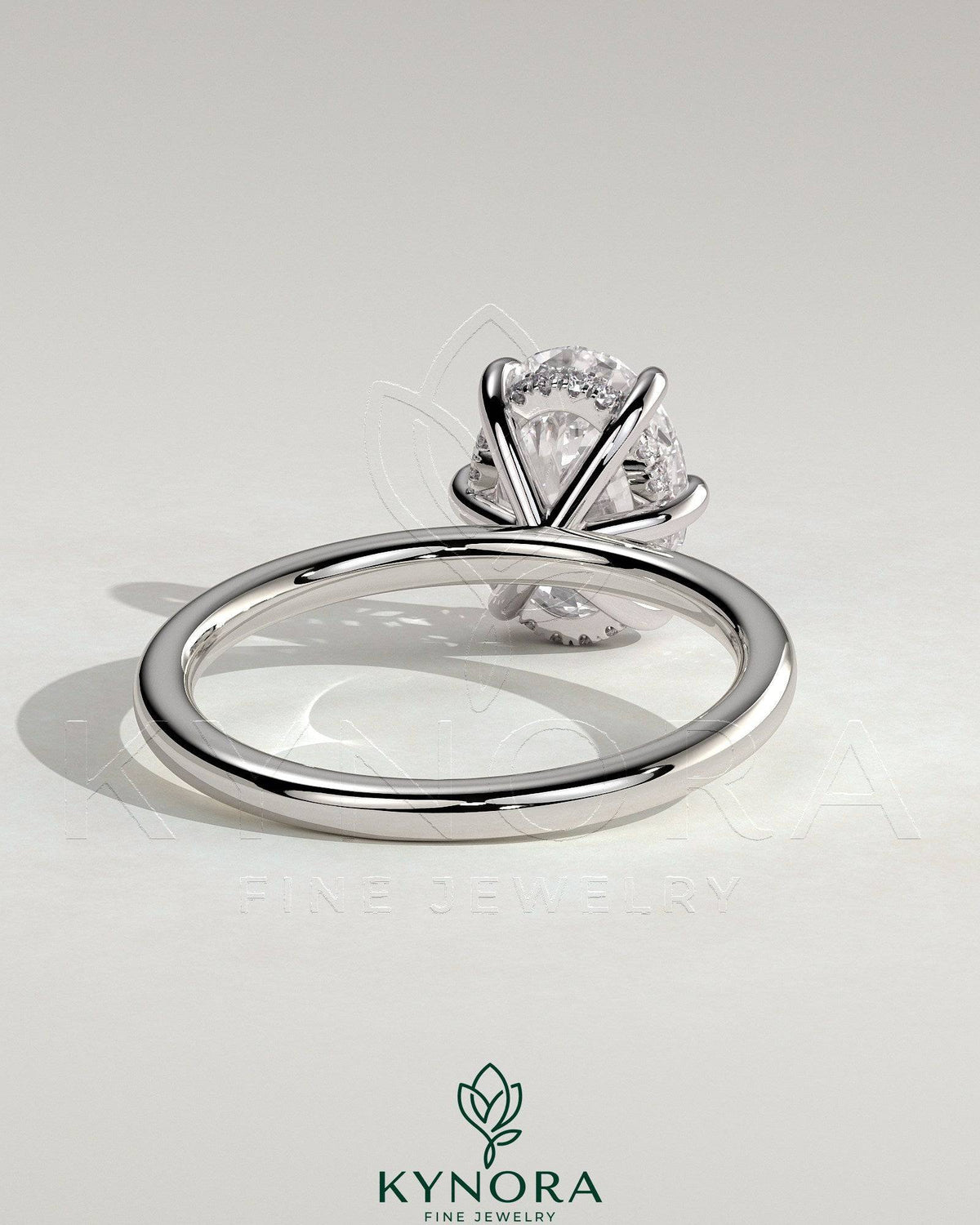 Kynora CJ 2ct oval claw solitaire engagement ring with hidden halo, showcasing a sparkling center diamond and elegant design.