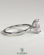 Kynora CJ 2ct oval claw solitaire engagement ring with hidden halo featuring a sparkling diamond centerpiece and intricate band detailing.