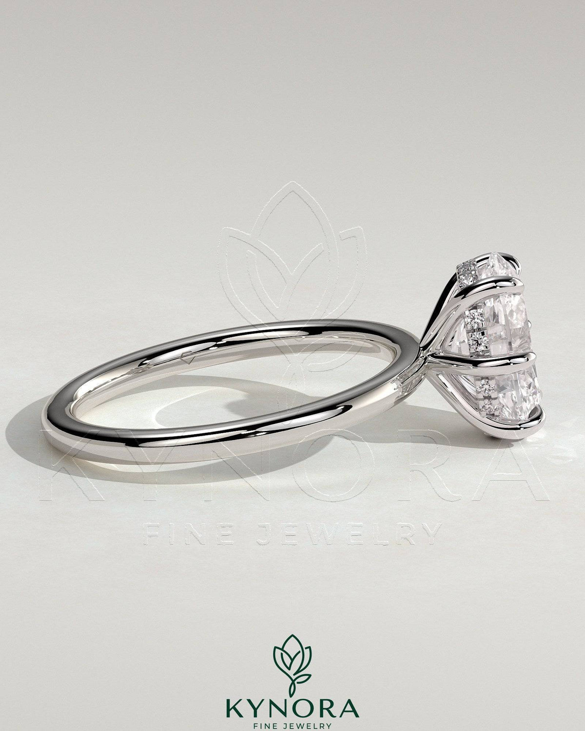 Kynora CJ 2ct oval claw solitaire engagement ring with hidden halo featuring a sparkling diamond centerpiece and intricate band detailing.