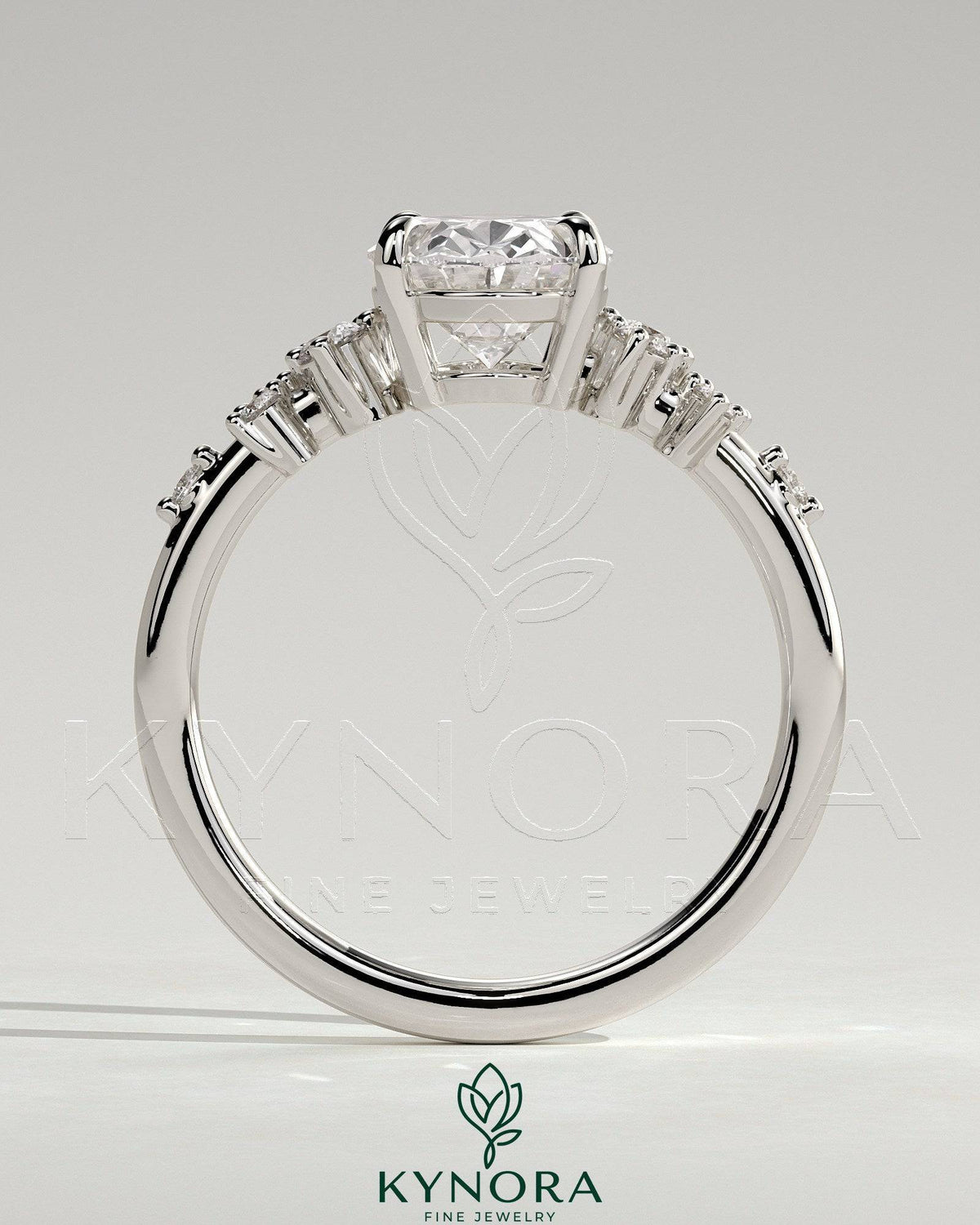 Kynora CJ 2ct oval claw solitaire engagement ring with three stones and clustered round shoulder stones, elegant jewelry design