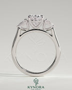 Kynora CJ 2ct oval claw trilogy engagement ring with pear side stones and cathedral setting, showcasing elegant diamond design.