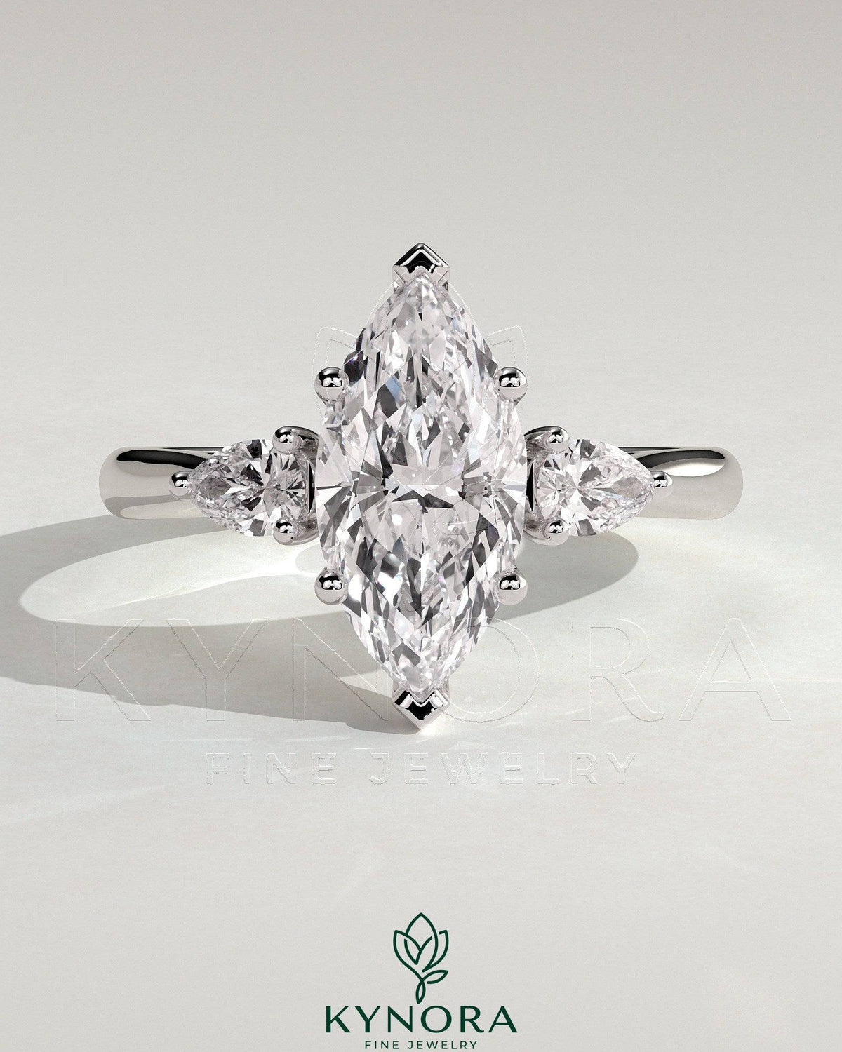 Kynora CJ 2ct marquise claw trilogy engagement ring with pear side stones and hidden halo, showcasing sparkling diamond design.
