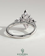 Kynora CJ 2ct marquise claw trilogy engagement ring with pear side stones and hidden halo, crafted in elegant jewelry design.