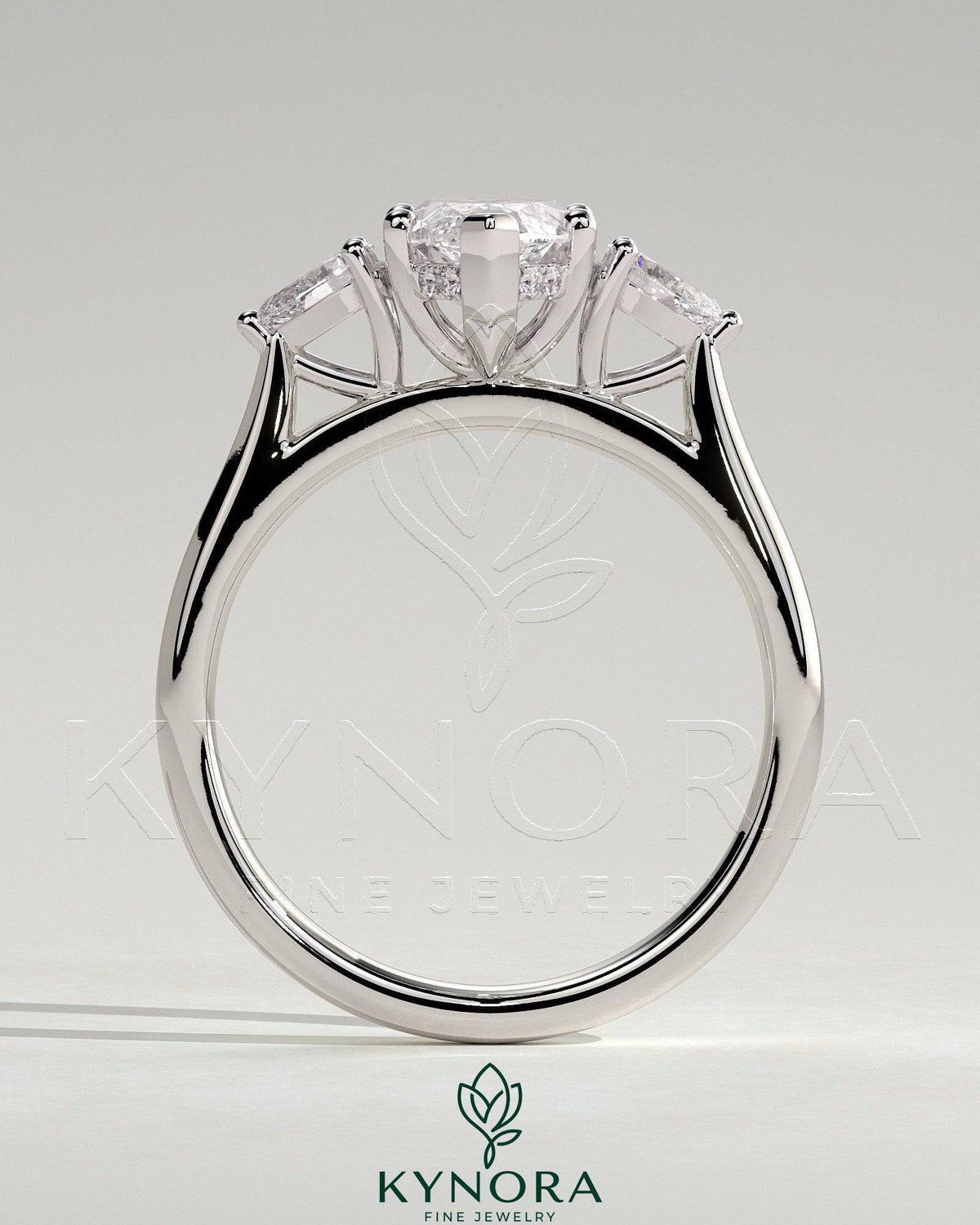 Kynora CJ 2ct marquise claw trilogy engagement ring with pear side stones and hidden halo, showcasing sparkling diamond details.