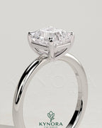 Kynora CJ 2-carat Asscher cut diamond solitaire engagement ring with a claw setting on a sleek band.