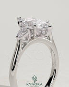 Kynora CJ 2ct marquise claw trilogy engagement ring with pear side stones and hidden halo, showcasing intricate diamond details.