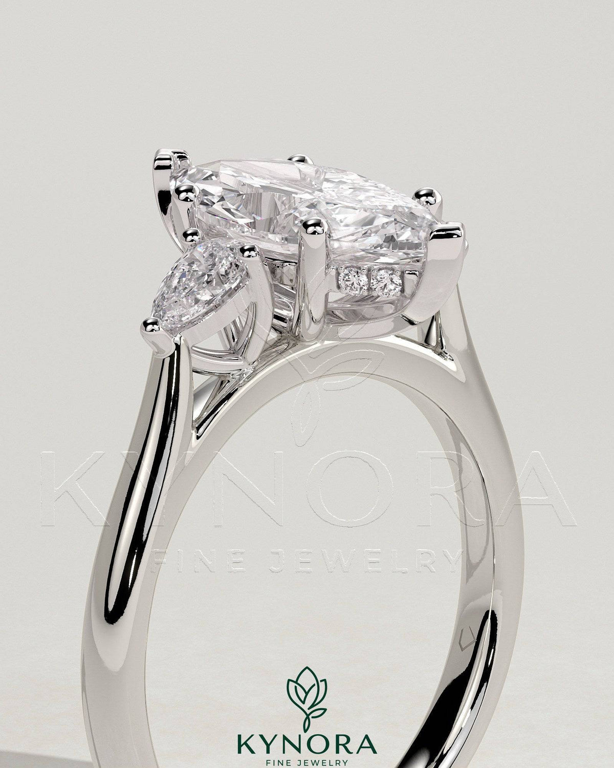 Kynora CJ 2ct marquise claw trilogy engagement ring with pear side stones and hidden halo, showcasing intricate diamond details.