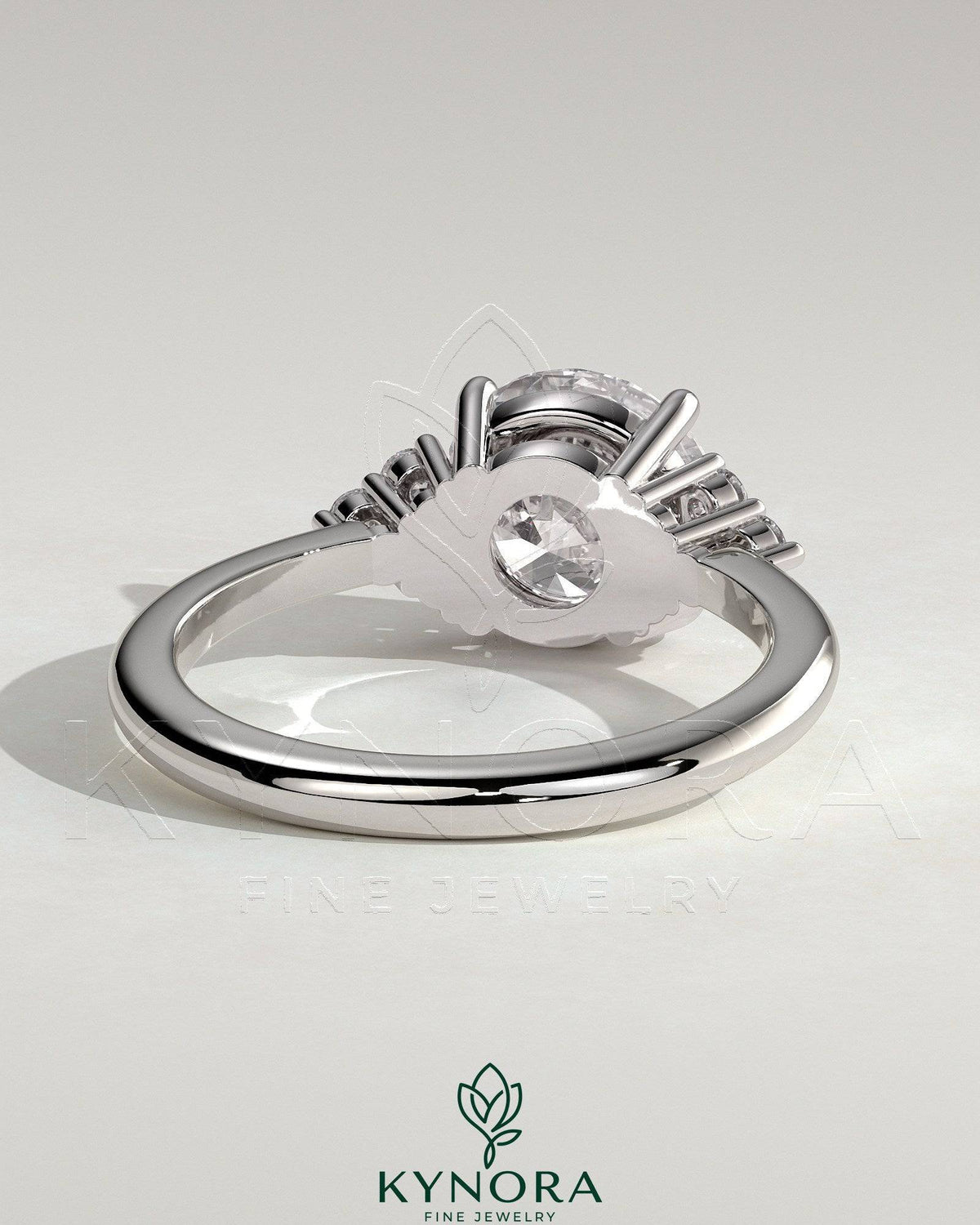 Kynora CJ 2ct round claw solitaire engagement ring with round shoulder stones, showcasing elegant craftsmanship and sparkling gemstones.
