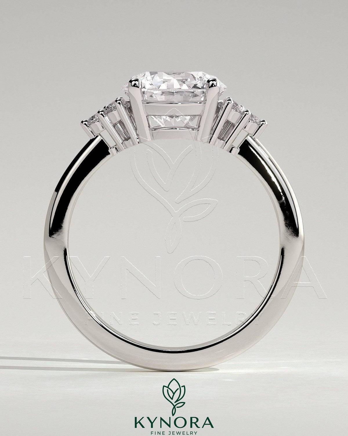 Kynora CJ 2ct round claw solitaire engagement ring with round shoulder stones, showcasing a sparkling center diamond and elegant design.