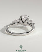 Kynora CJ 2ct oval claw trilogy engagement ring with pear side stones and open trellis gallery in sterling silver.