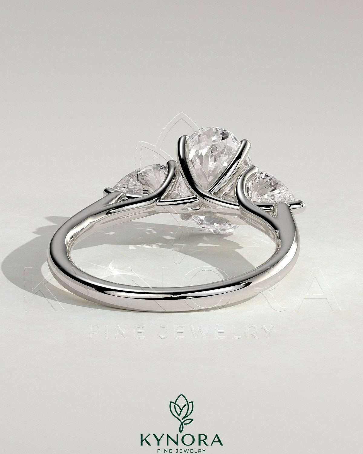 Kynora CJ 2ct oval claw trilogy engagement ring with pear side stones and open trellis gallery in sterling silver.