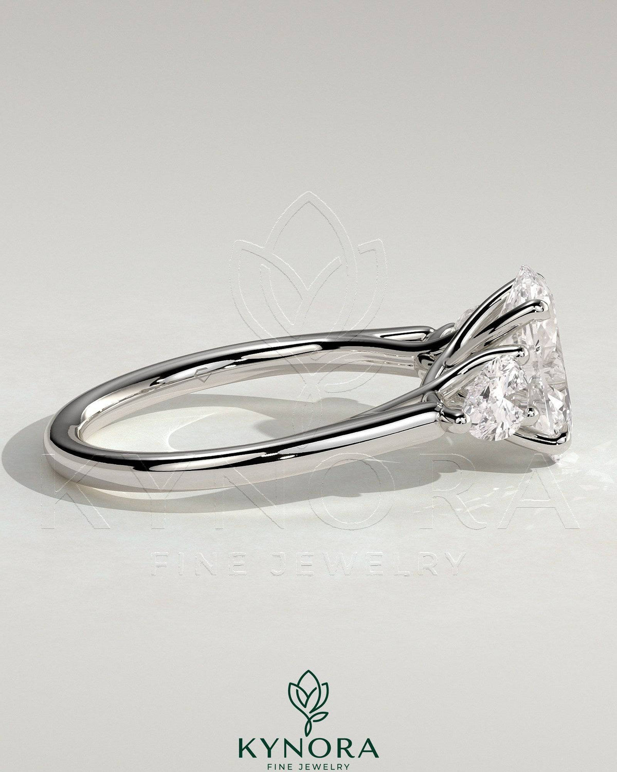 Kynora CJ 2ct oval claw trilogy engagement ring with pear side stones and open trellis gallery design in sterling silver.