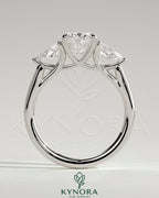 Kynora CJ 2ct oval claw trilogy engagement ring with pear side stones and open trellis gallery design.