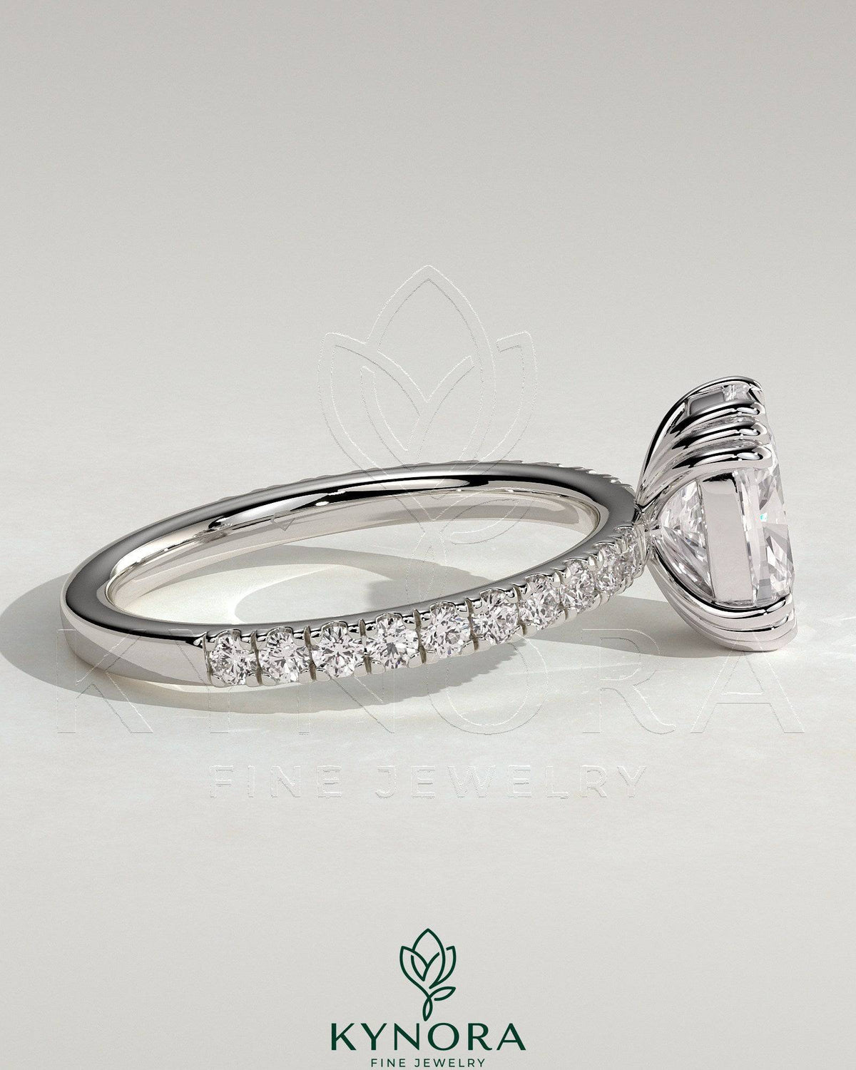 Kynora CJ 2ct elongated cushion cut solitaire engagement ring with triple claw setting and pave band, crafted in elegant jewelry design.