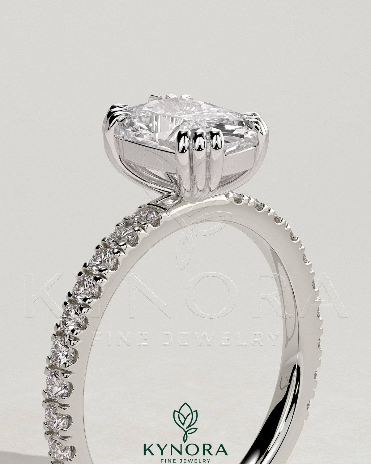 Kynora CJ 2ct elongated cushion triple claw solitaire engagement ring with pave band, showcasing a sparkling diamond and elegant design.