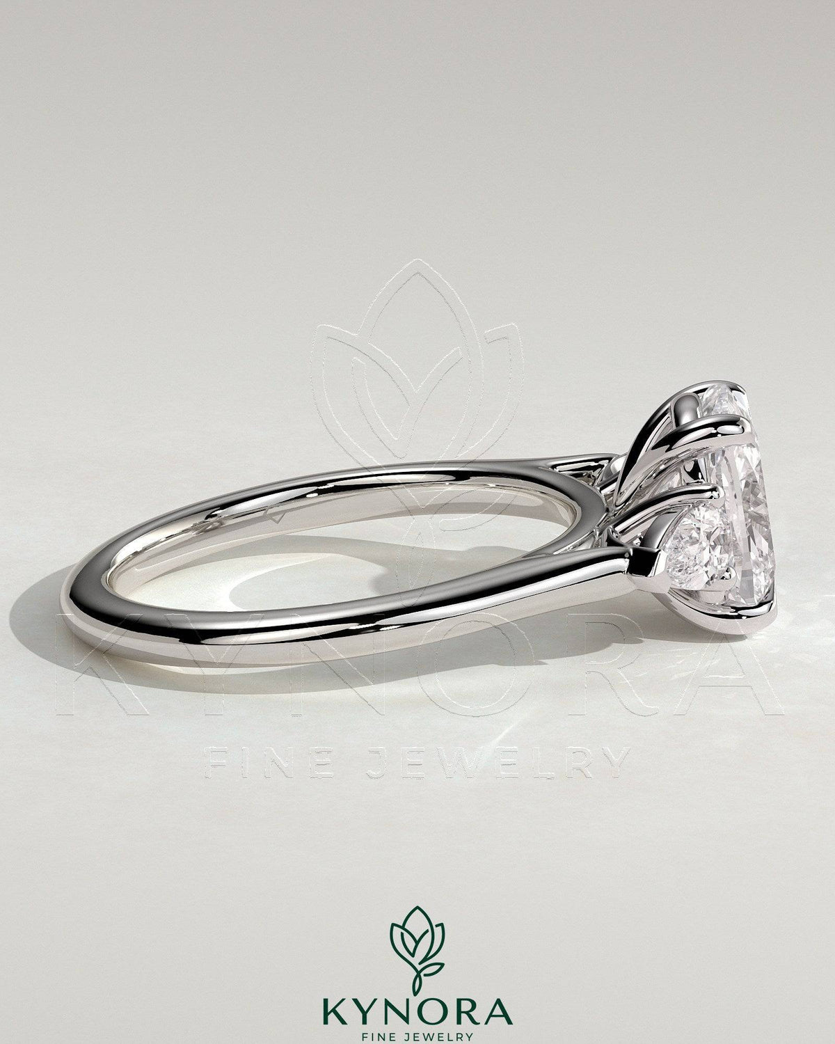 Kynora CJ 2ct elongated cushion cut trilogy engagement ring with pear side stones and cathedral setting, showcasing intricate jewel design.