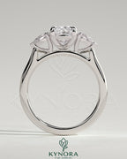 Kynora CJ 2ct elongated cushion claw trilogy engagement ring with pear side stones and cathedral setting, featuring elegant design.