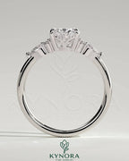 Kynora CJ 2ct oval claw solitaire engagement ring with pear-shaped accents and round shoulder stones, elegant three-stone design.