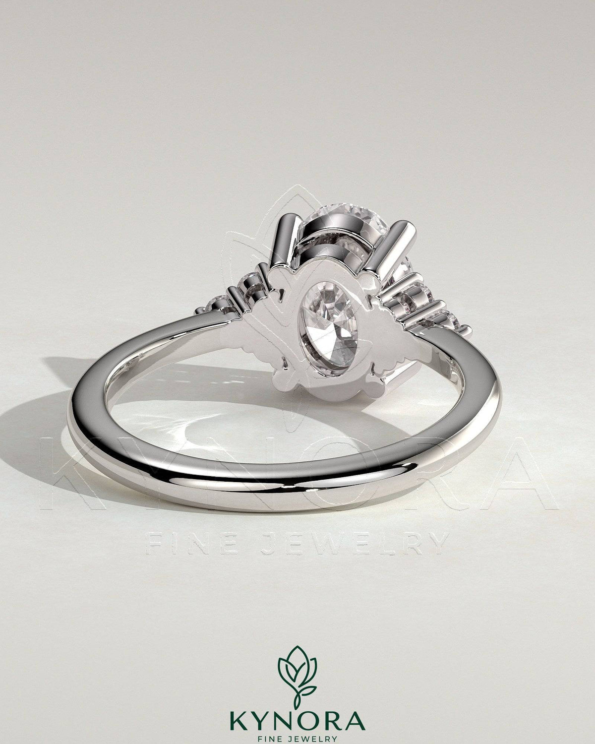 Kynora CJ 2ct oval claw solitaire engagement ring with round shoulder stones, showcasing a sparkling central gemstone and elegant design.
