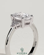 Kynora CJ 2ct oval claw solitaire engagement ring with round shoulder stones, showcasing a sparkling center gemstone and elegant band.