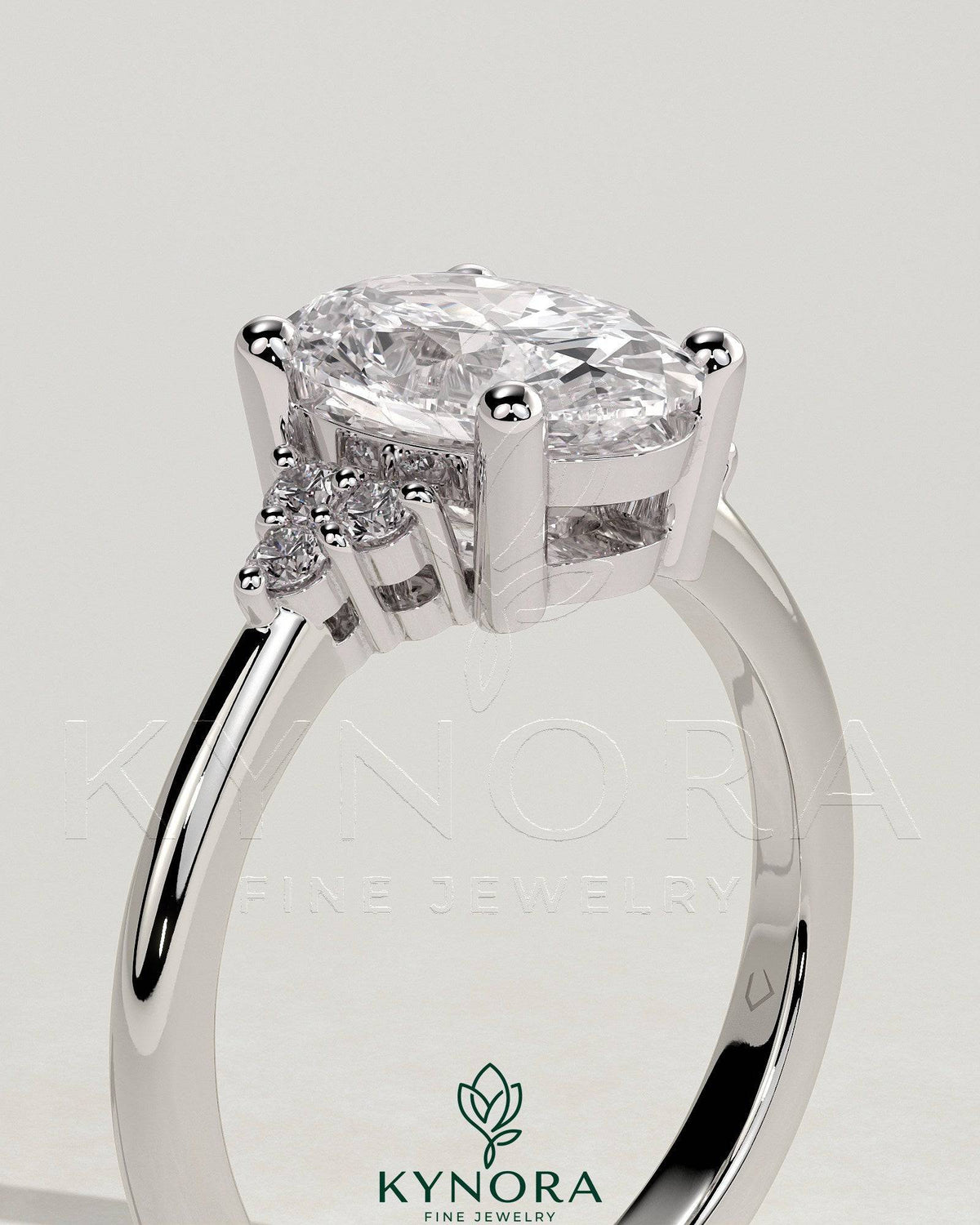 Kynora CJ 2ct oval claw solitaire engagement ring with round shoulder stones, showcasing a sparkling center gemstone and elegant band.