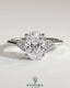 Kynora CJ 2ct oval claw solitaire engagement ring with round shoulder stones, showcasing a sparkling diamond design.