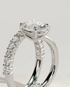 Kynora CJ 2ct oval claw solitaire engagement ring with angled pave band, showcasing a sparkling oval diamond and intricate band design.