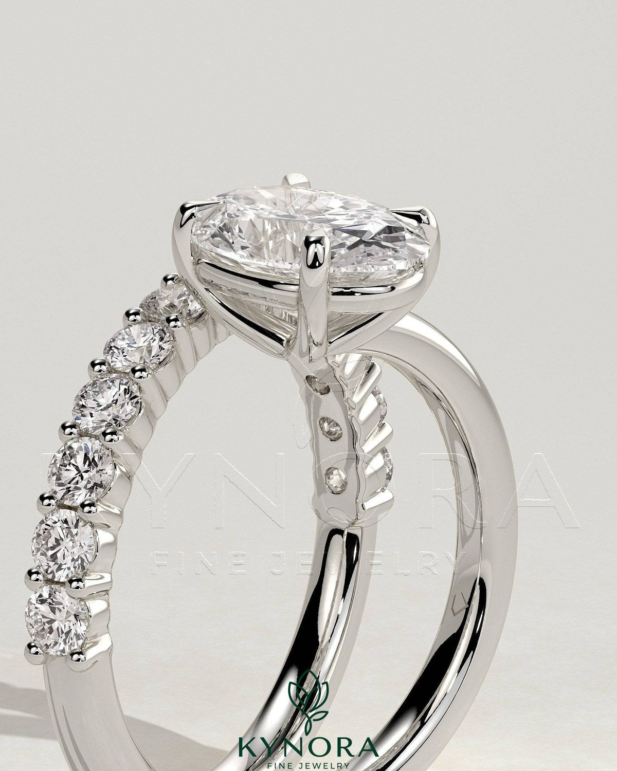 Kynora CJ 2ct oval claw solitaire engagement ring with angled pave band, showcasing a sparkling oval diamond and intricate band design.
