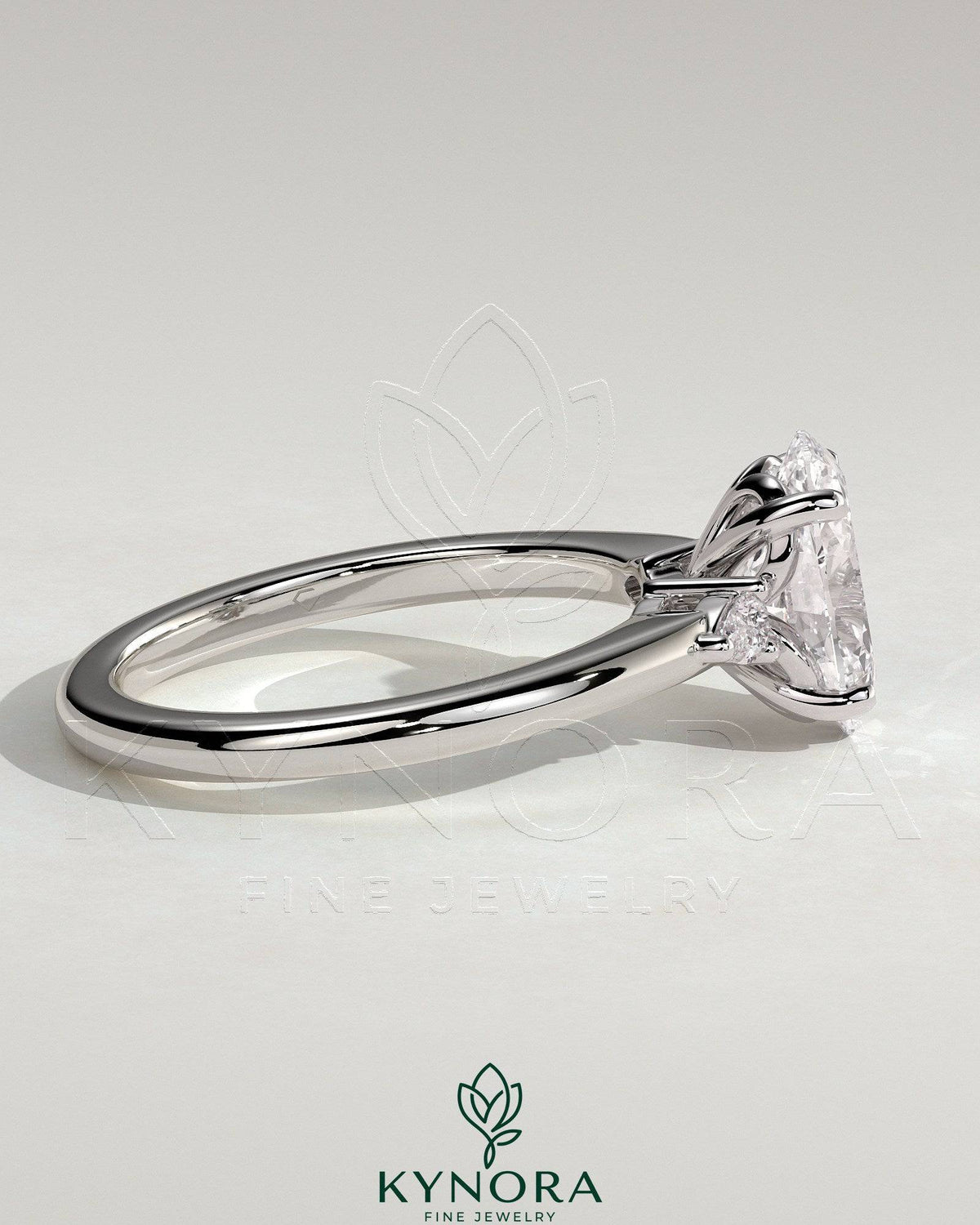 Kynora CJ 2ct oval claw trilogy engagement ring with pear side stones and tulip design in sterling silver.
