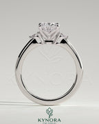 Kynora CJ 2ct oval claw trilogy engagement ring with pear side stones and tulip detail, showcasing fine craftsmanship and elegant design.