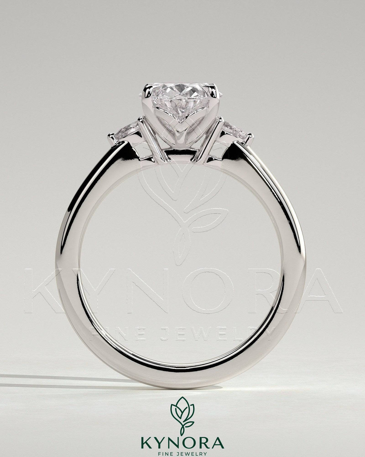 Kynora CJ 2ct oval claw trilogy engagement ring with pear side stones and tulip detail, showcasing fine craftsmanship and elegant design.