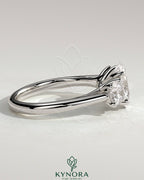 Kynora CJ 2ct oval claw trilogy engagement ring with round side stones, open trellis gallery, tapered band, fine jewelry.
