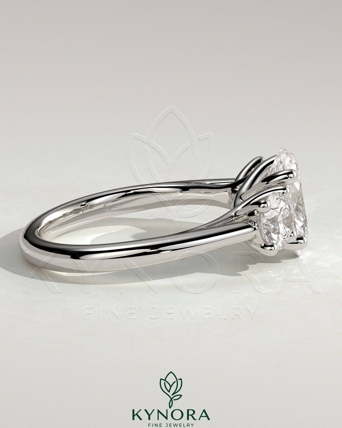Kynora CJ 2ct oval claw trilogy engagement ring with round side stones, open trellis gallery, tapered band, fine jewelry.