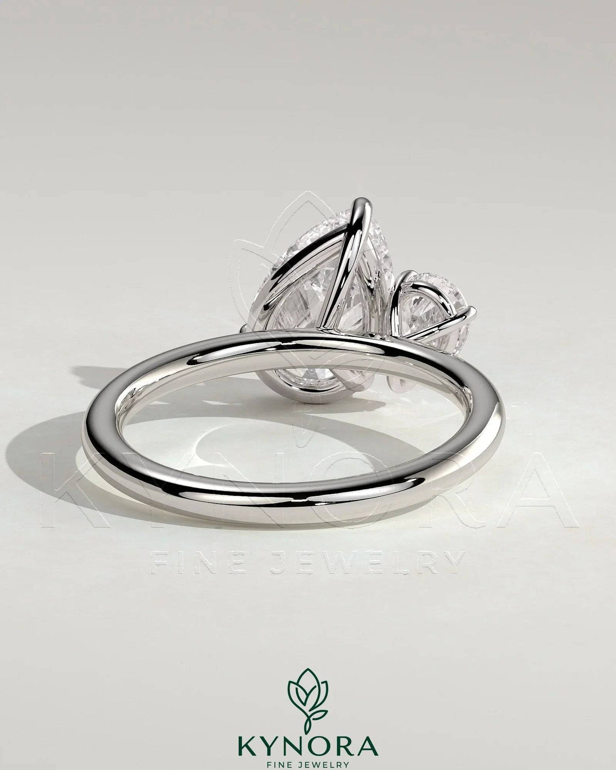 Kynora CJ 0.5ct and 1.25ct pear-shaped Toi et Moi engagement ring with claw settings featuring two pear-cut diamonds.