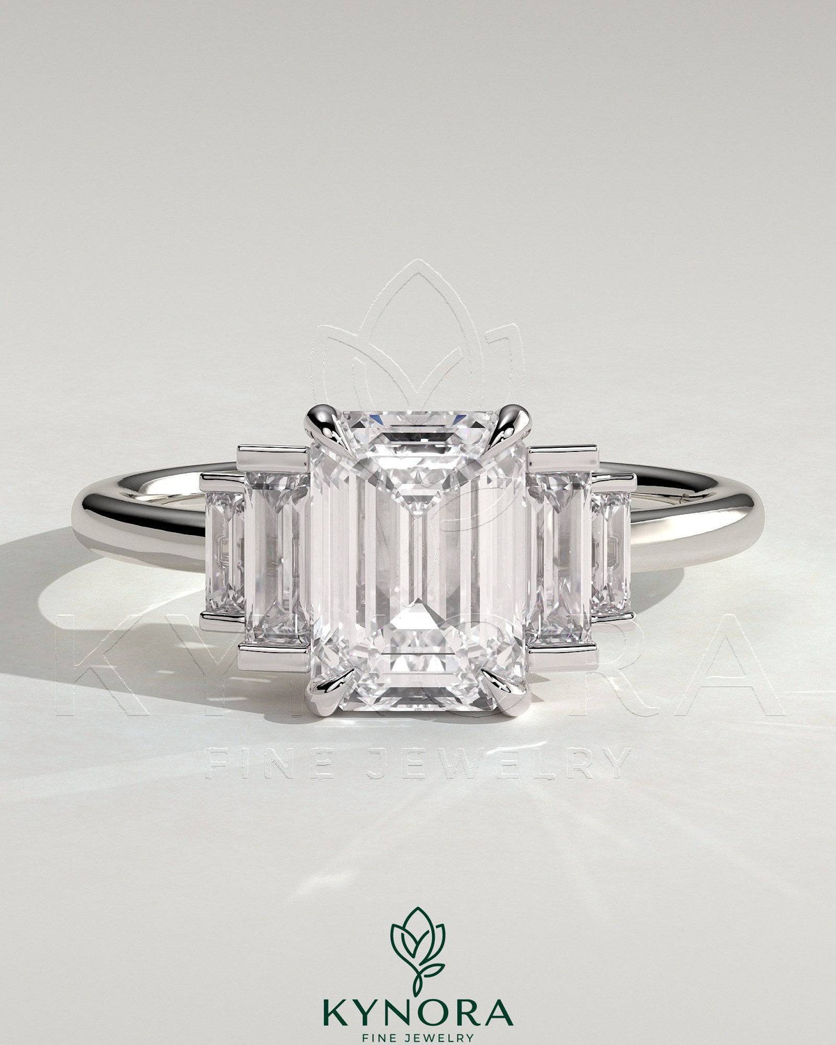 Kynora CJ 2ct emerald claw trilogy engagement ring with graduating baguette shoulder stones, three-stone diamond ring. Main image